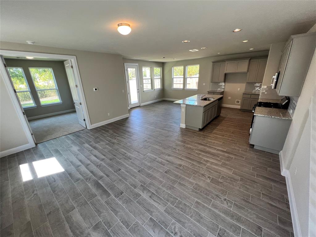 128 Free Stone Drive Georgetown, TX 78628 - Photo 21 of 29 Open-concept living space with wood-finish flooring extending into the kitchen