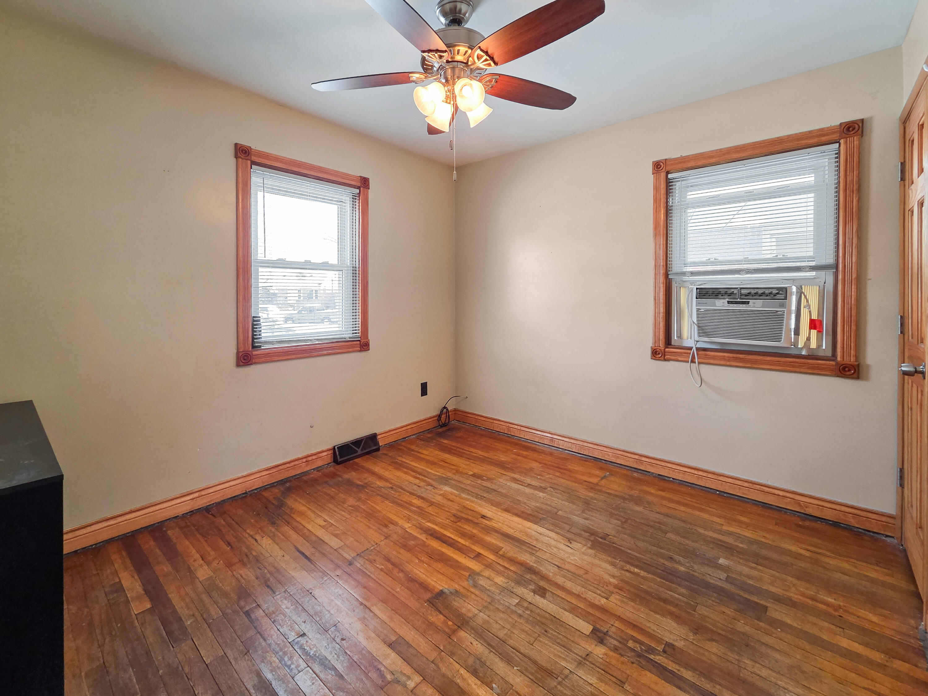 1472 Atlas Street Hammond, IN 46320 - Photo 12 of 27 a view of empty room with wooden floor and fan