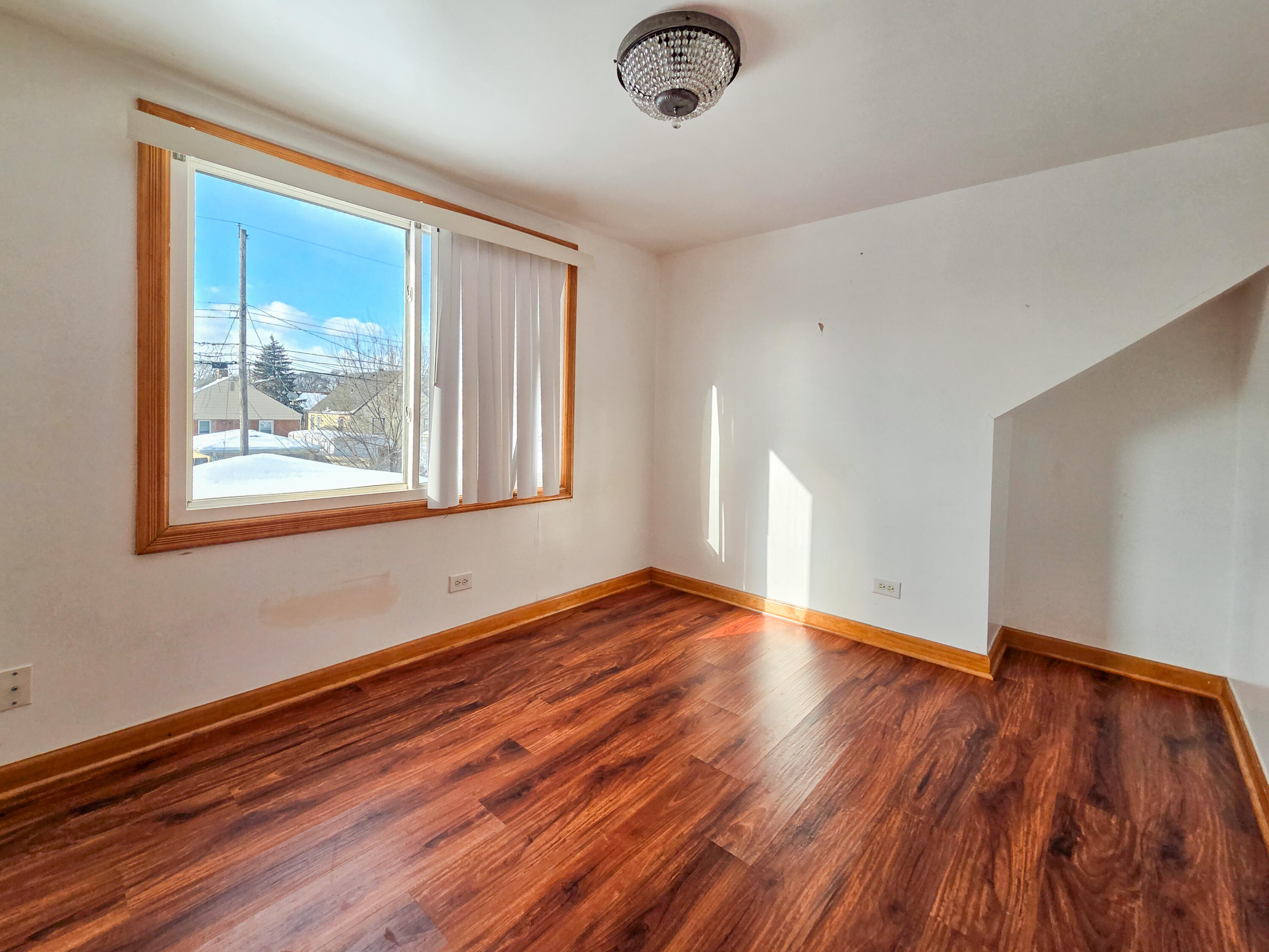 1472 Atlas Street Hammond, IN 46320 - Photo 20 of 27 a view of empty room with wooden floor and fan