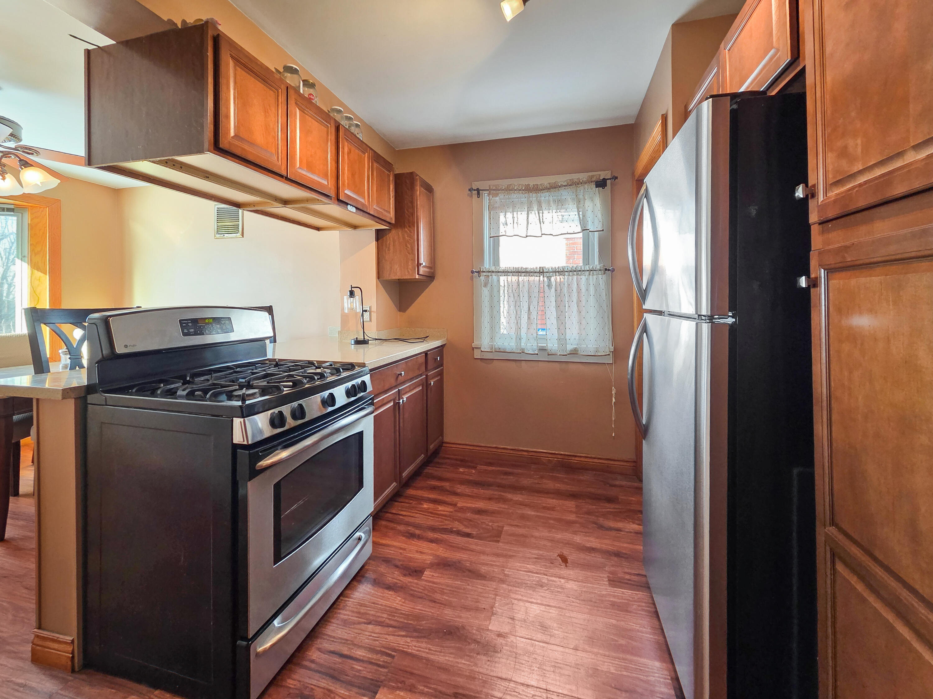 1472 Atlas Street Hammond, IN 46320 - Photo 5 of 27 a kitchen with wooden floors and a stove top oven