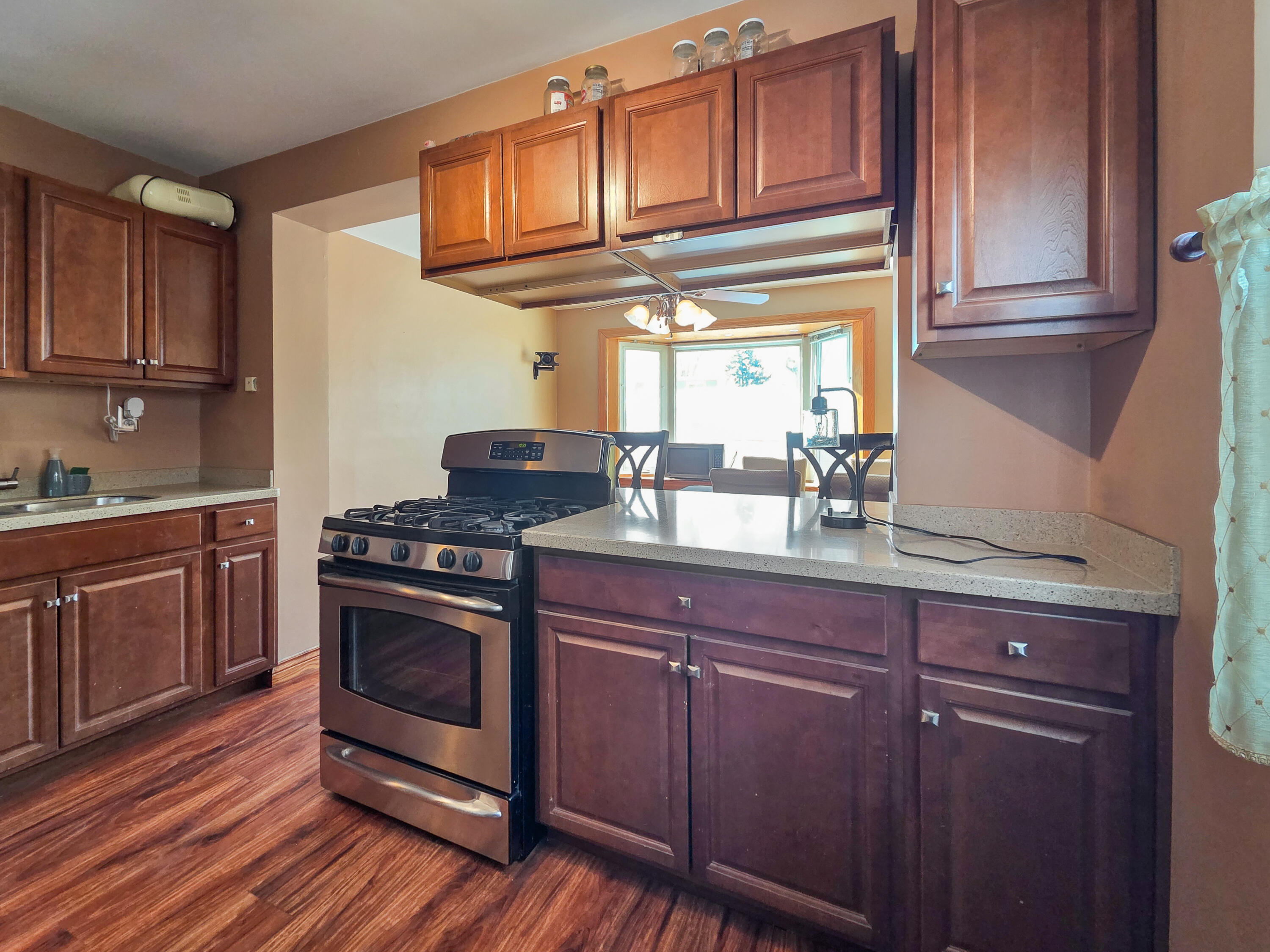 1472 Atlas Street Hammond, IN 46320 - Photo 7 of 27 a kitchen with stainless steel appliances granite countertop a sink stove and cabinets