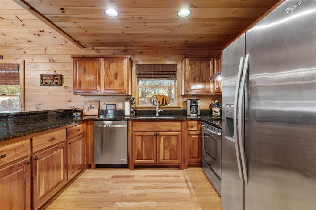 244 Indian Ridge Road Epworth, GA 30541 - Photo 23 of 47 a kitchen with stainless steel appliances granite countertop a sink a stove and a refrigerator