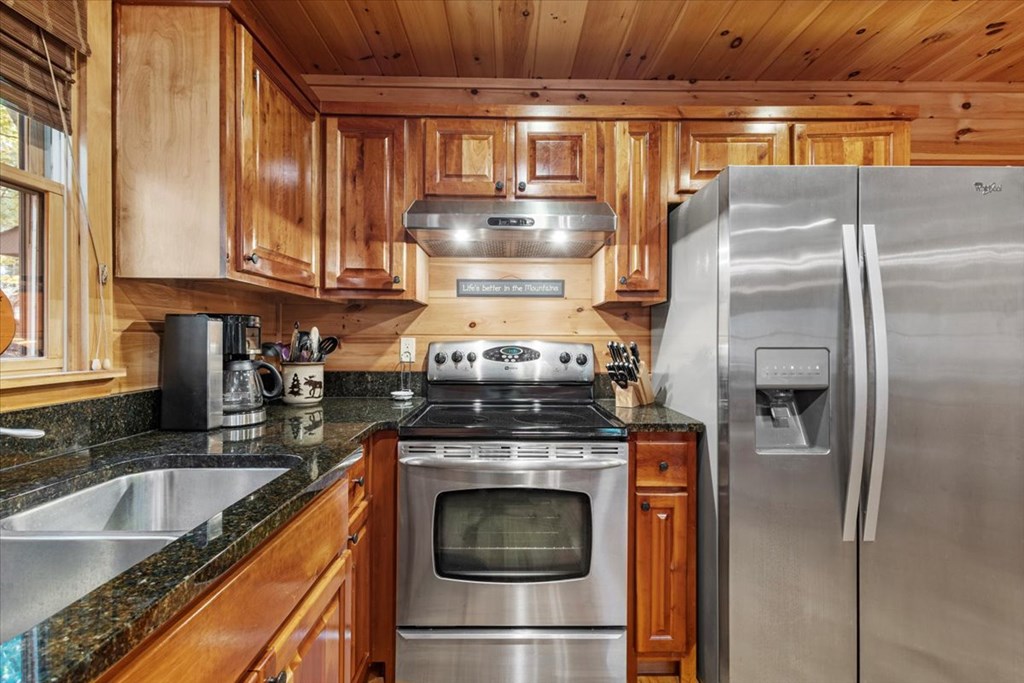 244 Indian Ridge Road Epworth, GA 30541 - Photo 24 of 47 a kitchen with granite countertop a sink and stainless steel appliances