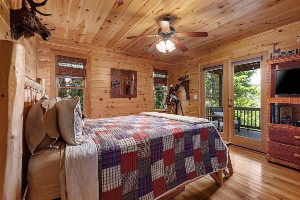 244 Indian Ridge Road Epworth, GA 30541 - Photo 28 of 47 a bedroom with a bed window and a flat screen tv