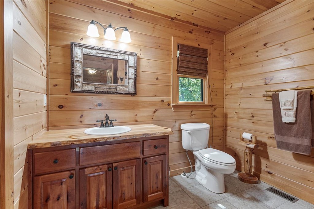 244 Indian Ridge Road Epworth, GA 30541 - Photo 37 of 47 a bathroom with a toilet sink and mirror