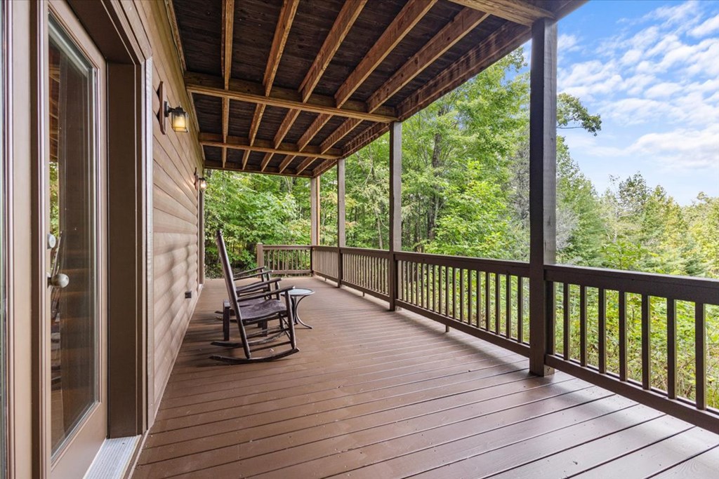244 Indian Ridge Road Epworth, GA 30541 - Photo 8 of 47 a view of a balcony with chairs and wooden floor