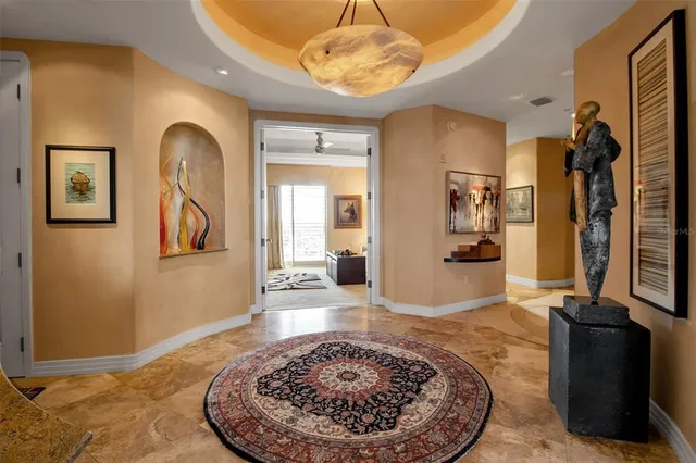 a living room with furniture a fireplace and a chandelier