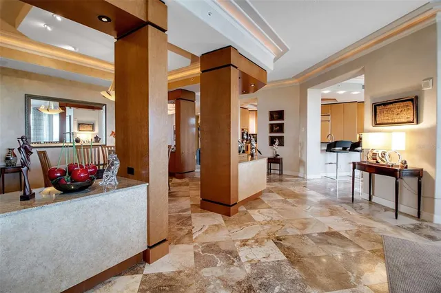 a living room with fireplace furniture and a large window