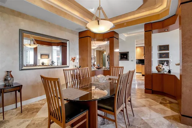 a spacious bedroom with a bed painting on wall and a large window