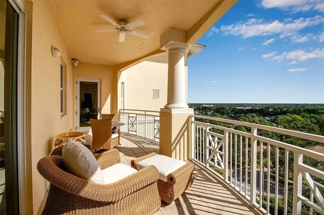 a living room with furniture a fireplace and a chandelier