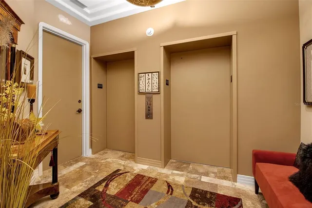 a view of a dining room with furniture and a chandelier