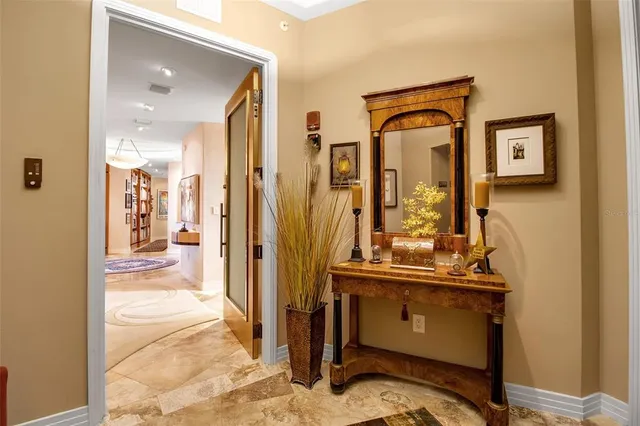 a living room with furniture and a floor to ceiling window