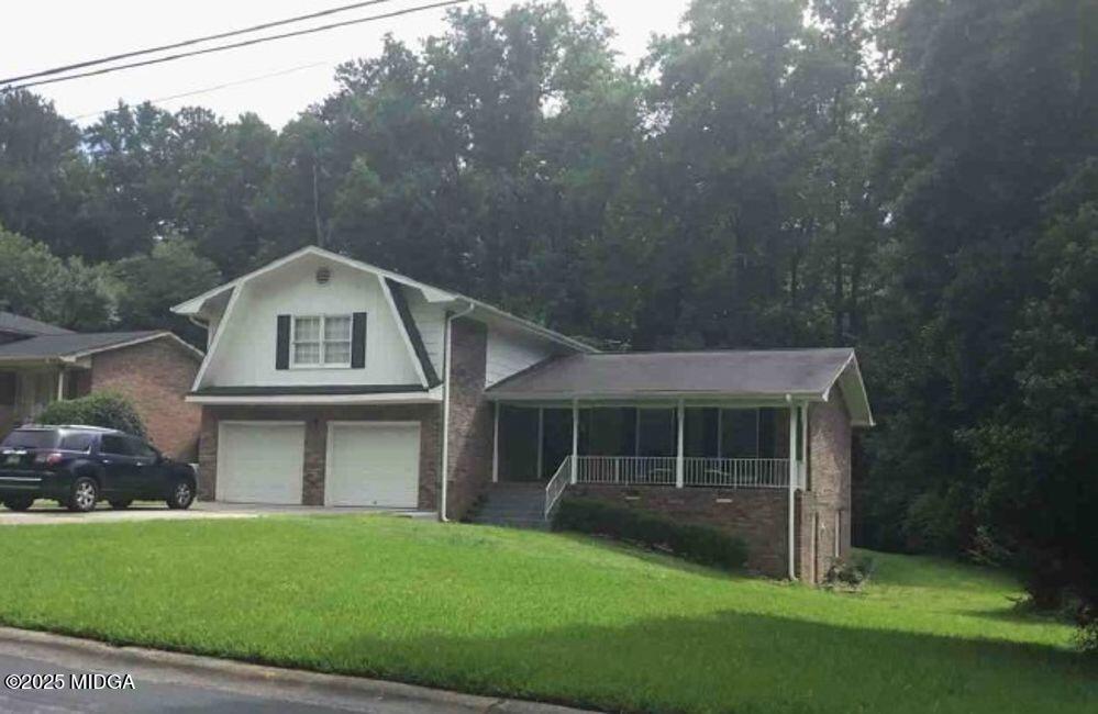 a front view of a house with a garden
