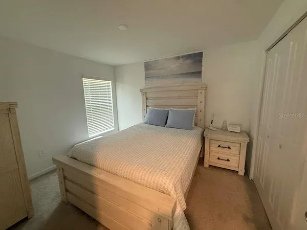 a bedroom with a bed and a window