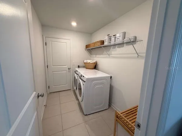 a utility room with cabinets washer and dryer