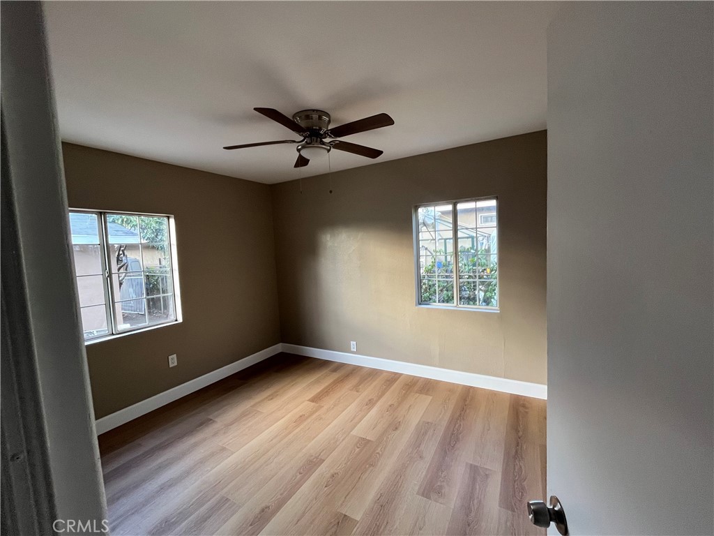 10915 Carmenita Road Whittier, CA 90605 - Photo 11 of 15 a view of an empty room with a window and wooden floor