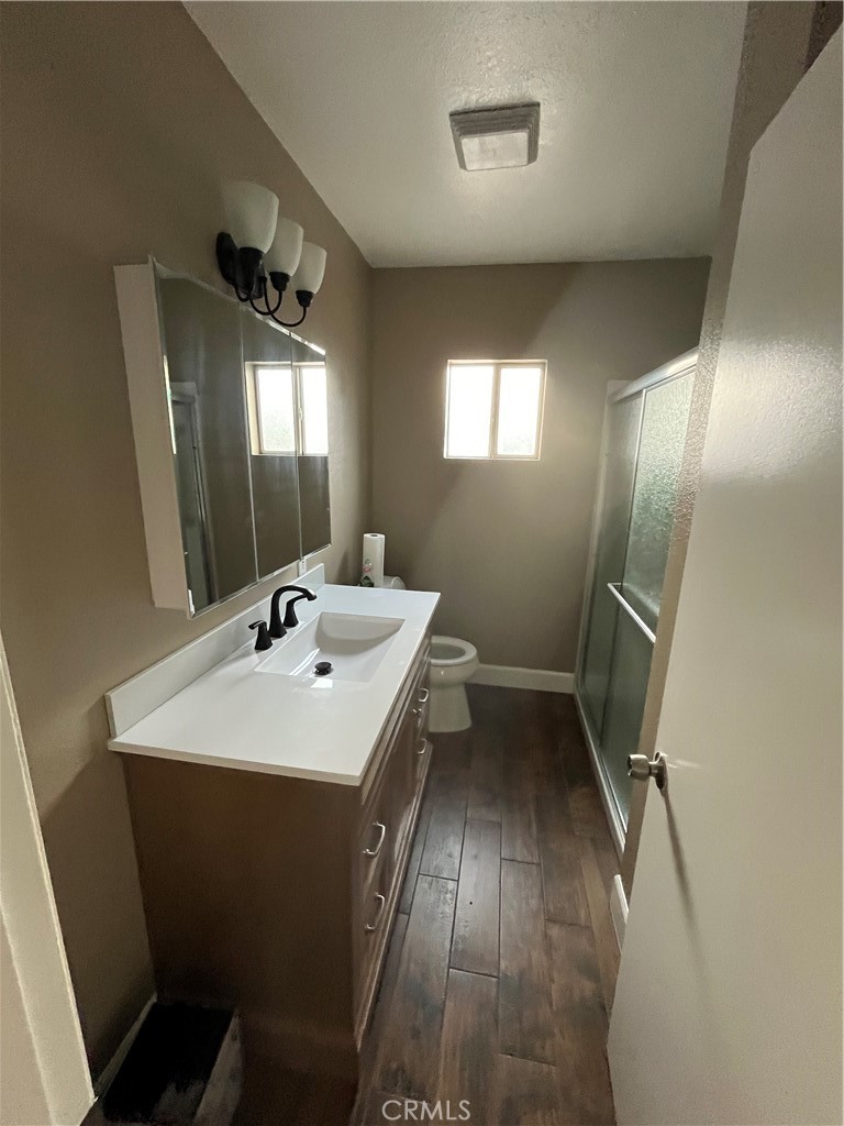 10915 Carmenita Road Whittier, CA 90605 - Photo 12 of 15 a bathroom with a sink toilet and mirror