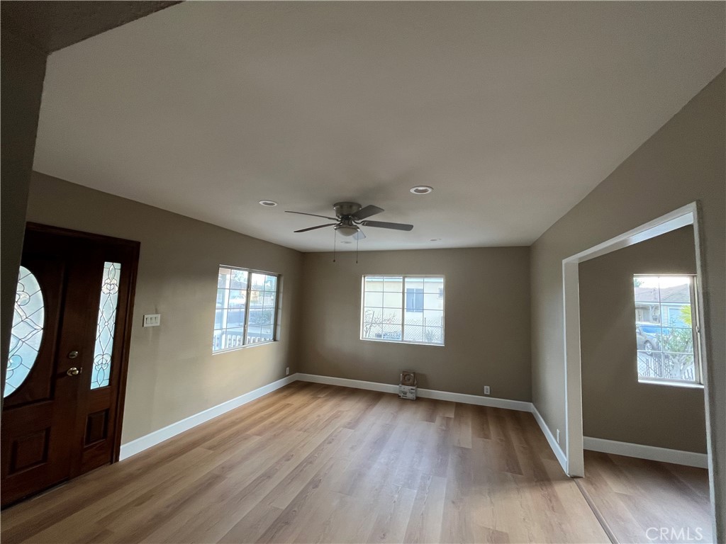 10915 Carmenita Road Whittier, CA 90605 - Photo 7 of 15 a view of an empty room with wooden floor and a window