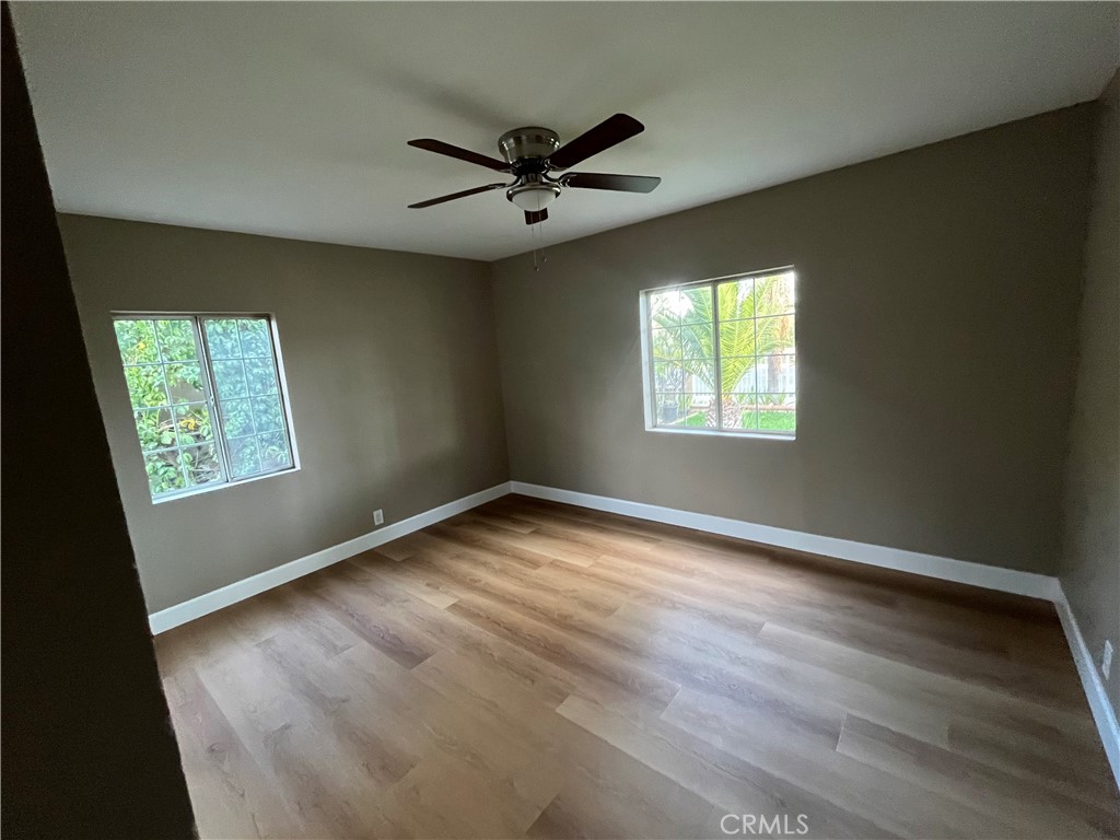 10915 Carmenita Road Whittier, CA 90605 - Photo 10 of 15 a view of empty room with wooden floor and fan