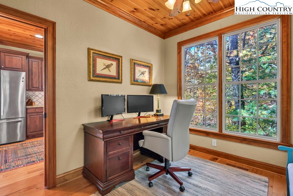 3664 Elk Ridge Road Ferguson, NC 28624 - Photo 25 of 46 a view of a workspace with furniture and a window