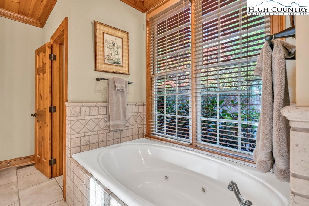3664 Elk Ridge Road Ferguson, NC 28624 - Photo 29 of 46 a bathroom with a bathtub and a shower