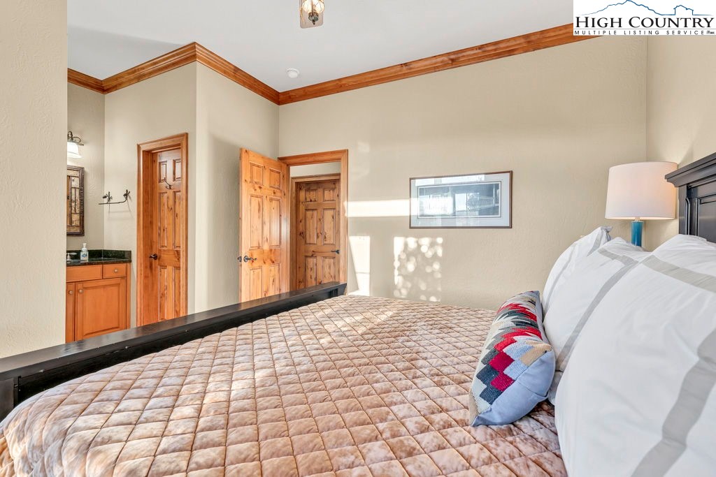 3664 Elk Ridge Road Ferguson, NC 28624 - Photo 35 of 46 a bedroom with a bed and a potted plant