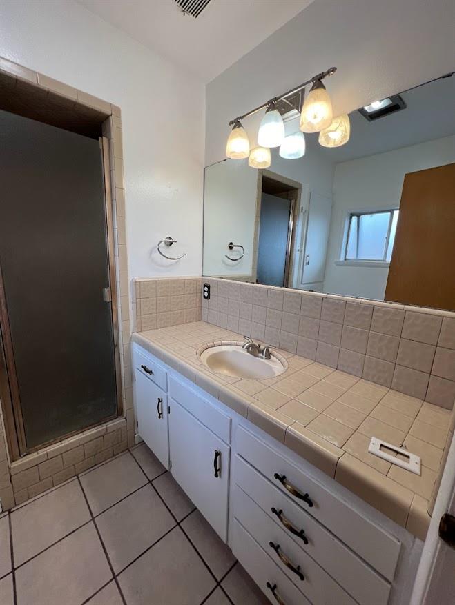 16109 East Manning Reedley, CA 93654 - Photo 13 of 30 a bathroom with a sink a large mirror and a shower