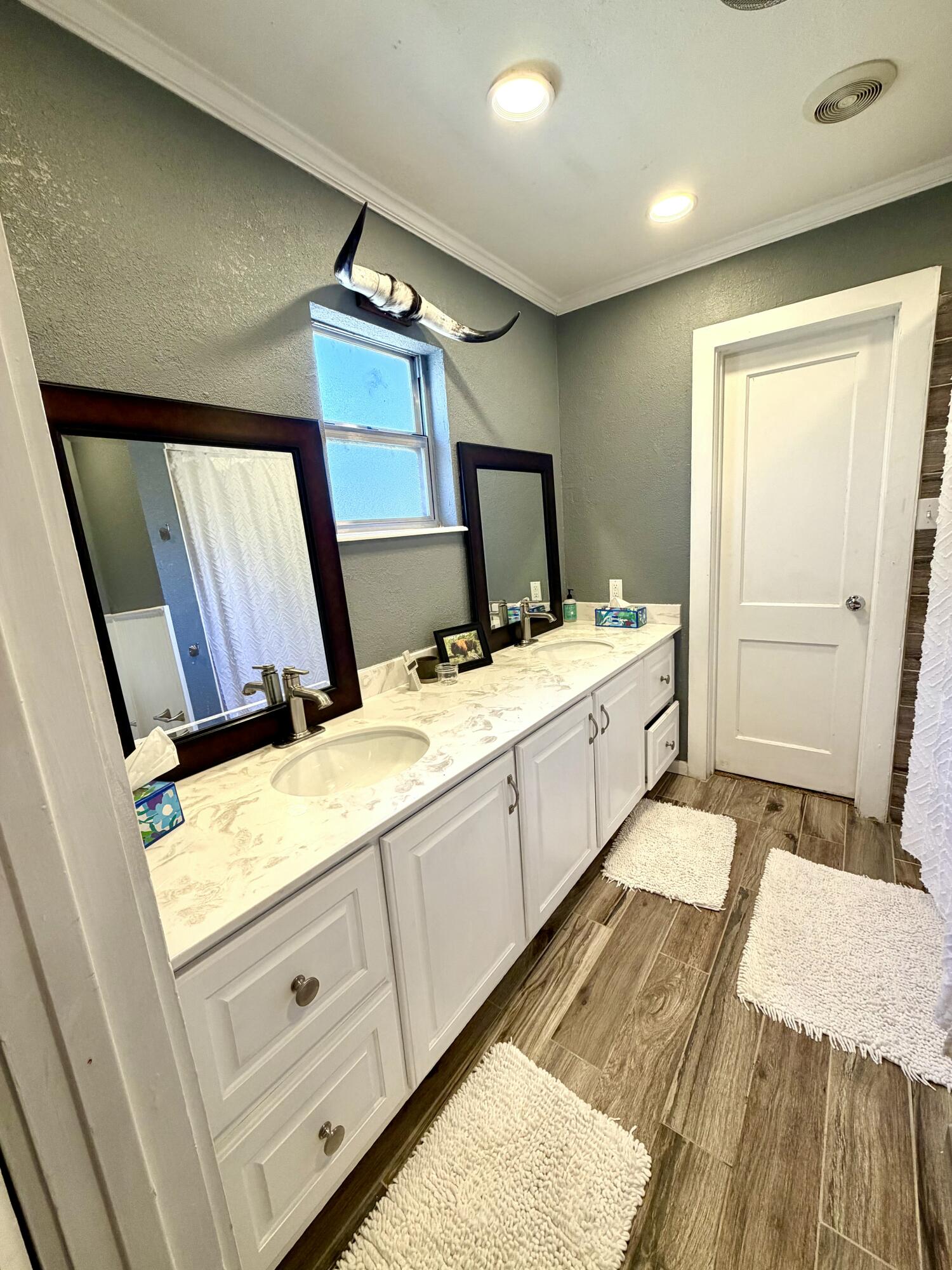 207 2nd Street Quitaque, TX 79255 - Photo 8 of 9 a spacious bathroom with a granite countertop sink and a mirror