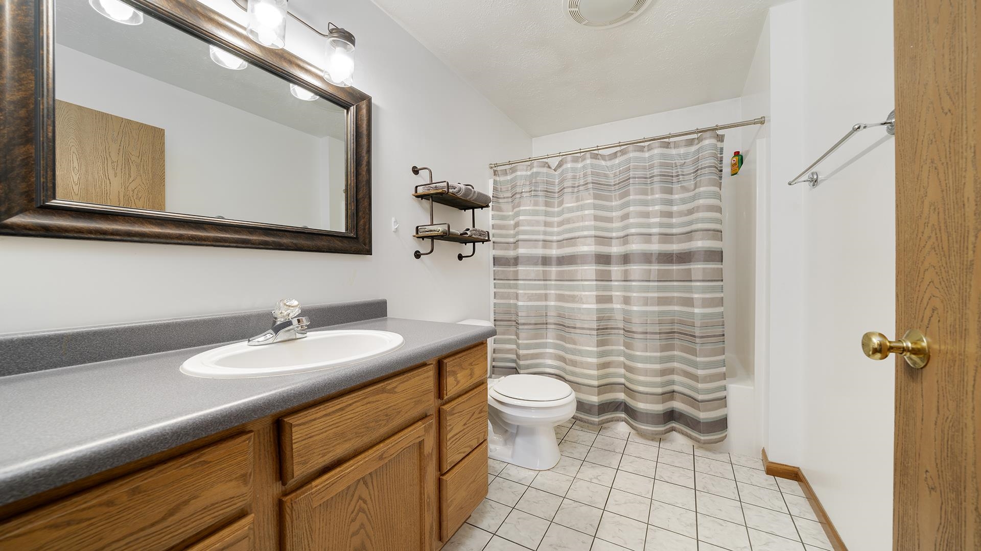 6749 Friday Road Byron, IL 61010 - Photo 17 of 36 a bathroom with a sink a toilet and a mirror