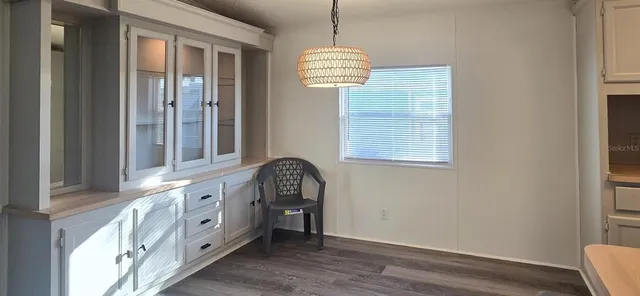 a view of an entryway with wooden floor