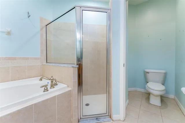 a en suite bathroom with a granite countertop sink and a mirror