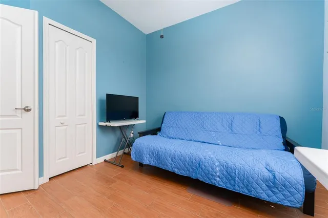 a spacious bedroom with a bed and a window