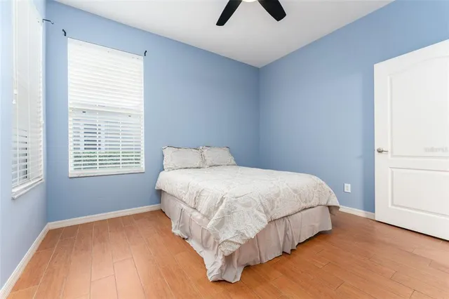 a bathroom with a granite countertop toilet a sink and a mirror