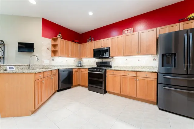 a kitchen with stainless steel appliances granite countertop a stove and a microwave