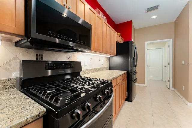 a patio with yard glass top table and chairs
