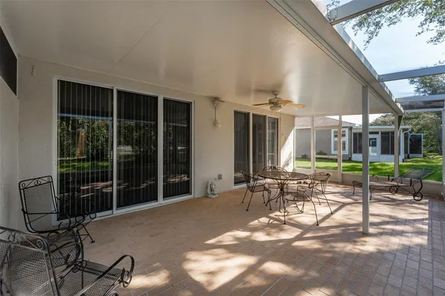 a view of a house with backyard and porch