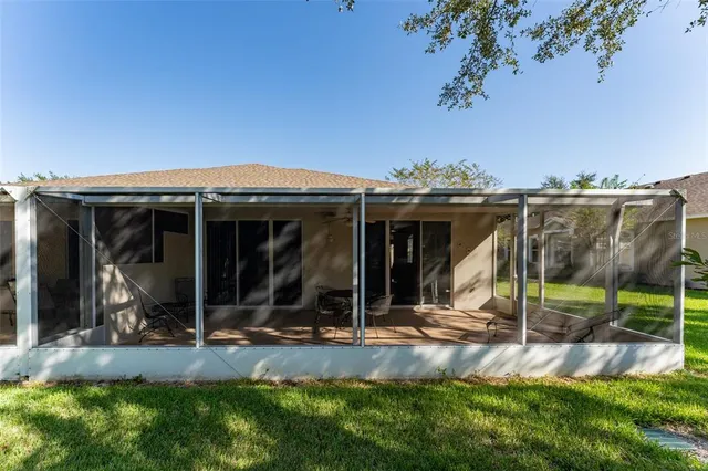 a view of a house with yard and sitting area