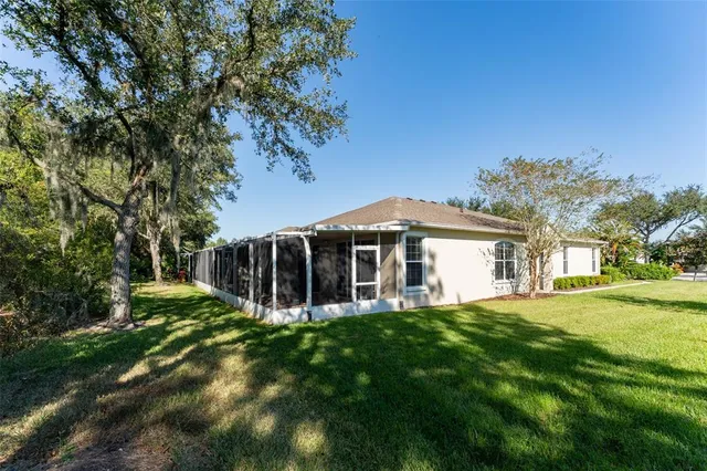 an aerial view of residential house with outdoor space and car parked
