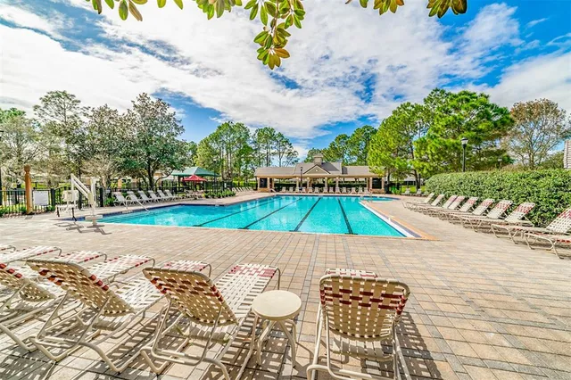 a swimming pool with outdoor seating and yard