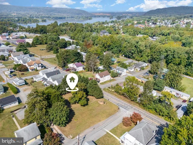 an aerial view of a house with a yard
