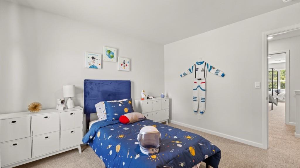 81 Buckthorn Way Dallas, GA 30132 - Photo 24 of 33 a bedroom with a bed and a chandelier