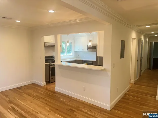 a view of a kitchen cabinets and wooden floor