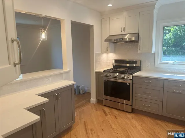 a kitchen with a stove and a refrigerator