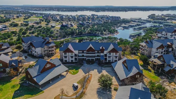 an aerial view of multiple houses with yard