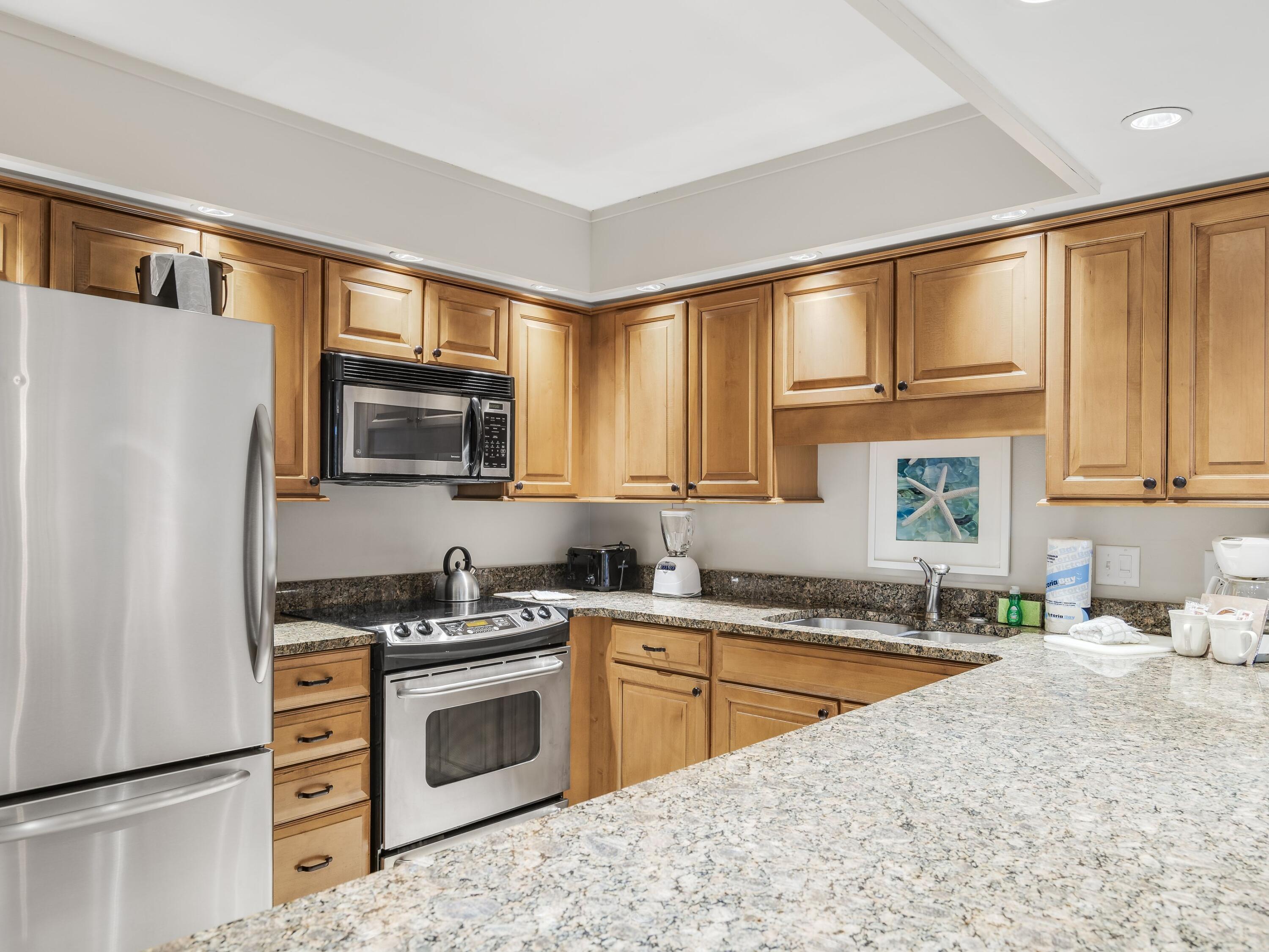 4218 Beachside 2, Unit 218 Miramar Beach, FL 32550 - Photo 10 of 29 a kitchen with stainless steel appliances a stove sink microwave and refrigerator