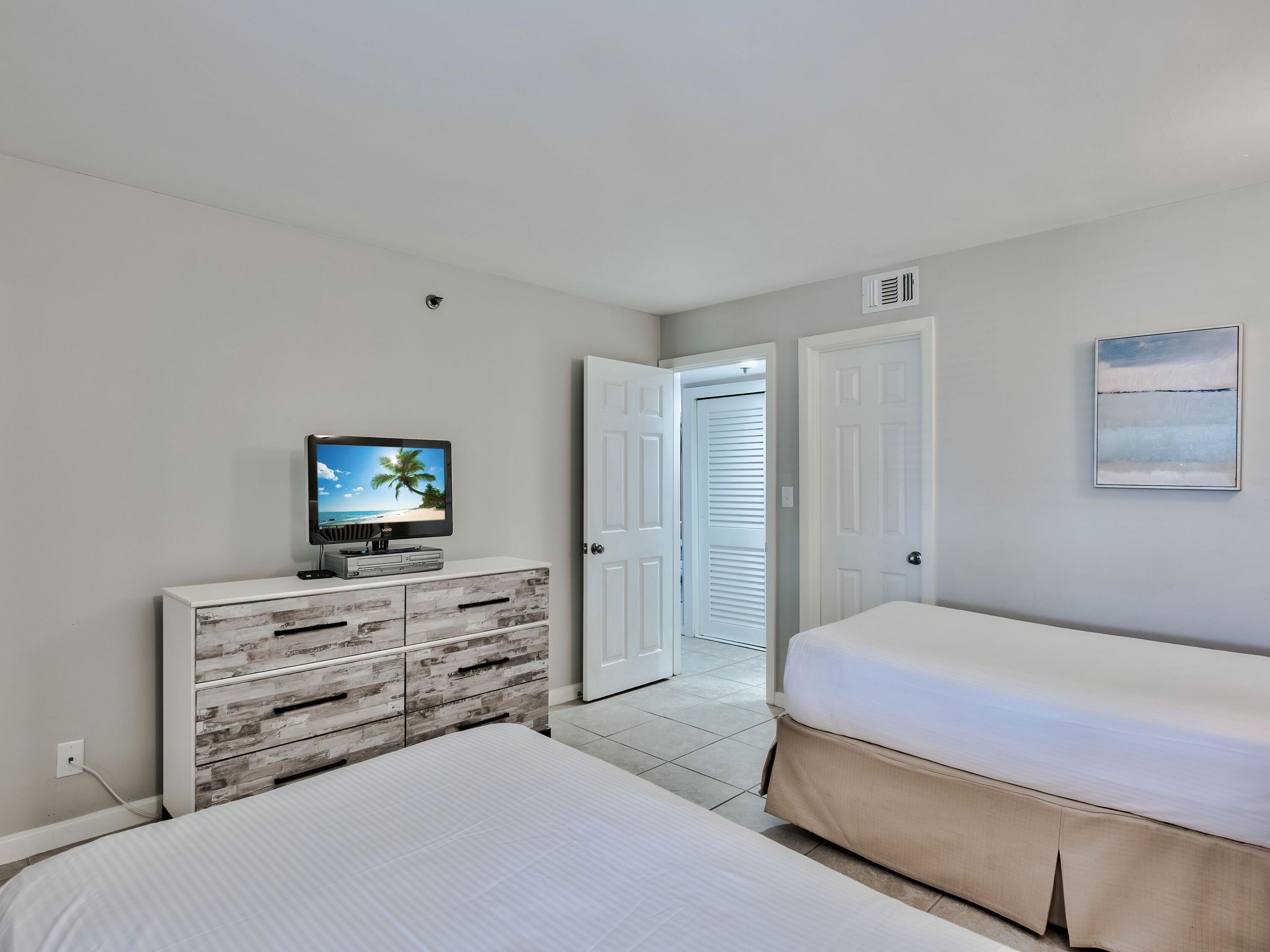 4218 Beachside 2, Unit 218 Miramar Beach, FL 32550 - Photo 19 of 29 a bedroom with a bed and a flat screen tv