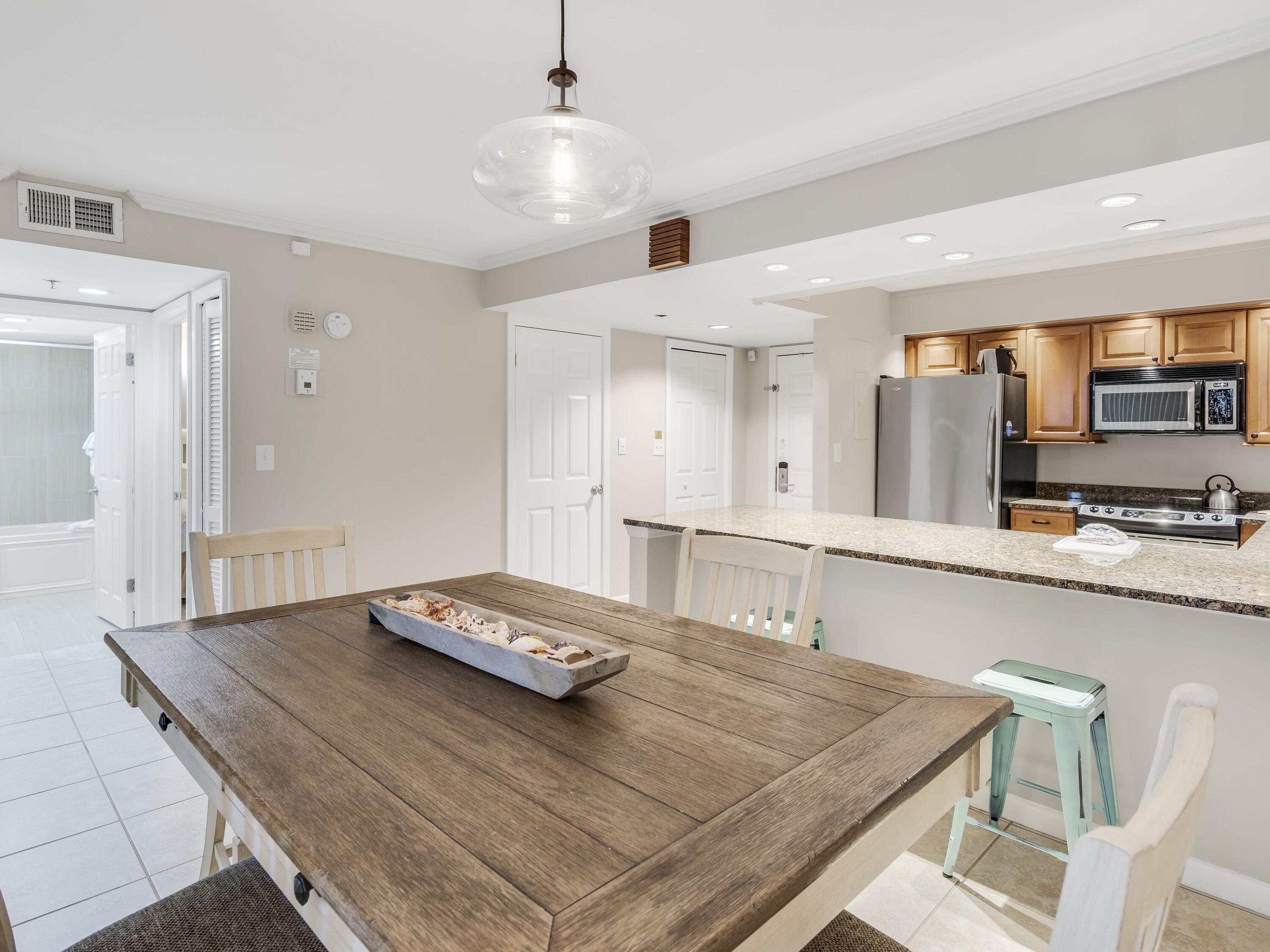 4218 Beachside 2, Unit 218 Miramar Beach, FL 32550 - Photo 8 of 29 a kitchen with stainless steel appliances granite countertop a sink and a stove