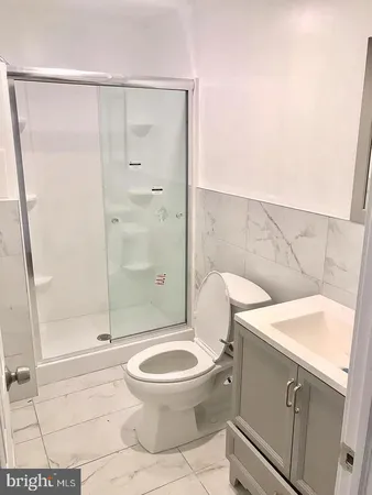 a kitchen with a refrigerator sink and wooden cabinets