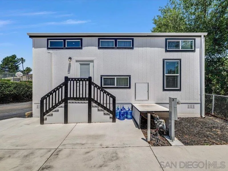 a view of a house with couches and deck