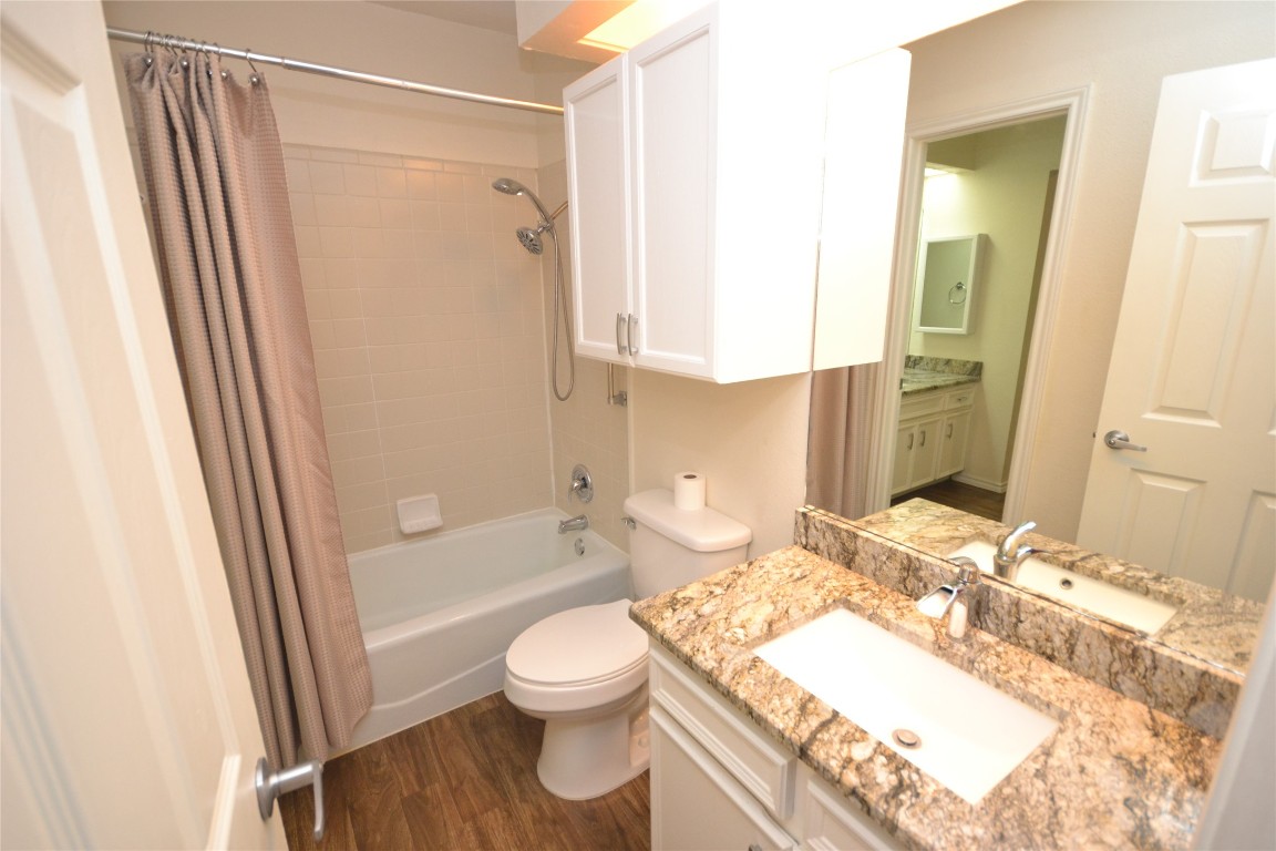 500 Hesters Crossing Road, Unit 205 Round Rock, TX 78681 - Photo 14 of 18 a bathroom with a granite countertop sink toilet and shower
